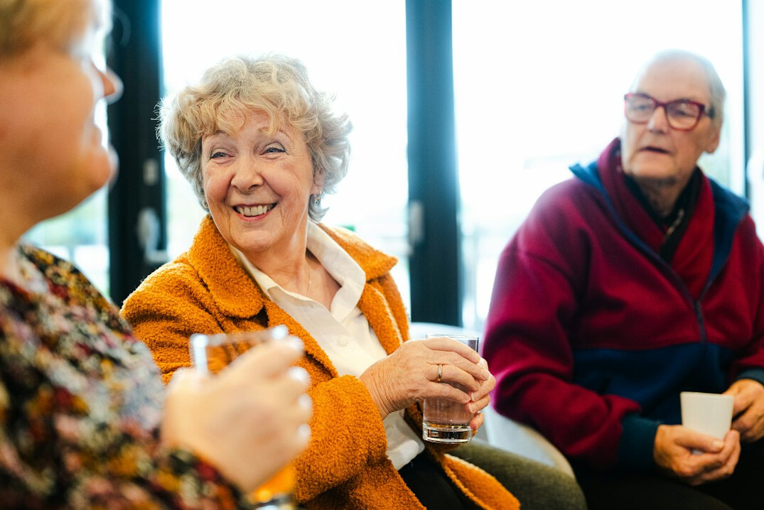 group of elderly people playing cards